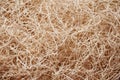 Wooden wool fibers close up background.Shredded wood excelsior for filling inside.Natural sustainable material for wrapping.