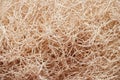 Wooden wool fibers close up background.Shredded wood excelsior for filling inside.Natural sustainable material for wrapping.