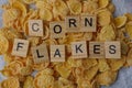 Wooden word lies on a pile of dry cornflakes