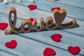 Wooden word love with heart romance with white coffee cup of hot chocolate and small marshmallows. Minimal Royalty Free Stock Photo