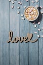 Wooden word love with heart romance with white coffee cup of hot chocolate and small marshmallows. Minimal Royalty Free Stock Photo