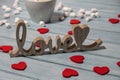 Wooden word love with heart romance with white coffee cup of hot chocolate and small marshmallows. Minimal Royalty Free Stock Photo