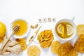 Wooden word sick, Tea with lemon, thermometer, ginger, honey, tablets and dry leaves on a white background top view flat lay. Royalty Free Stock Photo