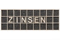 Wooden word ZINSEN on black sand rectangular Royalty Free Stock Photo