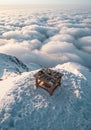 A wooden workbench with various tools sits on a snowy mountain peak. Surrounding Royalty Free Stock Photo