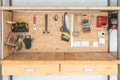 Wooden workbench at workshop. Lot of different tools for diy and repair works. Wood desk for product placement