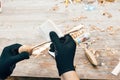 Wooden workshop. Hands grinding spoon from wood, working with sandpaper. Process of making wooden spoon and polishing, chisel and Royalty Free Stock Photo