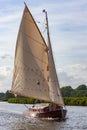 Wooden yacht sailing on the Norfolk Broads - England Royalty Free Stock Photo