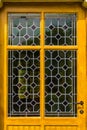 Wooden yellow door with tainted glass pattern in diverse colors, Vintage background