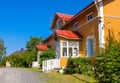 Wooden yellow house with red roof in Scandinavian style Royalty Free Stock Photo