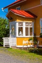 Wooden yellow house with red roof in Scandinavian style Royalty Free Stock Photo