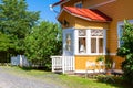 Wooden yellow house with red roof in Scandinavian style Royalty Free Stock Photo