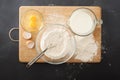 Wooder chopping board ,flour and milk on chalkboard background Royalty Free Stock Photo