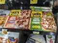 Woodinville, WA USA - circa April 2022: Angled view of Udi`s brand gluten free pizzas for sale inside the freezer section of a