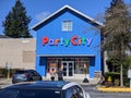 Woodinville, WA / USA - circa April 2021: Street view of a couple entering a Party City on a bright, sunny day Royalty Free Stock Photo