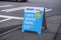 Woodinville, WA USA - circa February 2022: Angled view of a sandwich board on a sidewalk, advertising Zoom + Care just around the