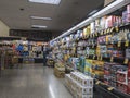 Woodinville, WA USA - circa October 2020: View of a grocery store employee restocking the shelves in the beer aisle