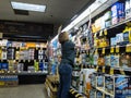 Woodinville, WA USA - circa October 2020: View of a grocery store employee restocking the shelves in the beer aisle