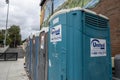 Woodinville, WA USA - circa September 2021: Street view of a line up of port-a-potties in the downtown area on a cloudy day