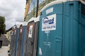 Woodinville, WA USA - circa September 2021: Street view of a line up of port-a-potties in the downtown area on a cloudy day