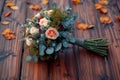 Woodland elegance close up of rustic bouquet on wooden floor