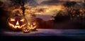 A woodland sunset with the spooky evil glowing eyes of Jack O` Lanterns