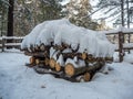 Woodpile stacked of firewood under the snow, Novosibirsk, Russia