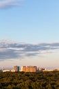 Woods and apartment buildinds under blue sky Royalty Free Stock Photo