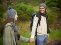 Woods, hiking and happy couple holding hands on mountain and travel with backpack, nature and bonding. Outdoor Royalty Free Stock Photo