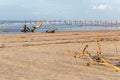 Woods logs beach sea shore bush branch pollution dirt, ocean waves sand. Royalty Free Stock Photo