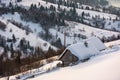 Woodshed on hillside in deep snow