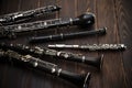 Woodwind instruments lie on a wooden surface