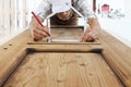 Woodwork concept, carpenter with the meter makes the shape of a