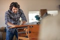 Woodworker cutting wood with a table saw in his workshop Royalty Free Stock Photo