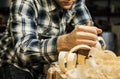 Woodworker planing wood in his workshop