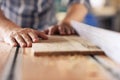 Woodworker sawing planks of wood in his carpentry workshop Royalty Free Stock Photo