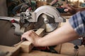 Woodworker sawing wood in his carpentry workshop Royalty Free Stock Photo