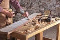 Woodworker using chisel to smooth down wood Royalty Free Stock Photo