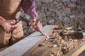 Woodworker using chisel to smooth down wood