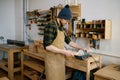 Woodworker using circular saw blade for cutting wood plank Royalty Free Stock Photo