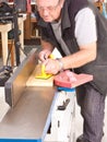 Woodworker using a jointing machine Royalty Free Stock Photo