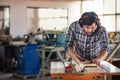 Woodworker using a table saw in his workshop Royalty Free Stock Photo