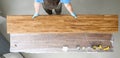 Woodworker varnishes wood sheets, beautiful color