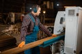 Woodworker works on machine, lumber industry Royalty Free Stock Photo