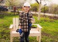 Woodworking. Happy boy in helmet with a screwdriver making a gar