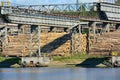 Woodworking plant on the river bank. Using the river to transport raw materials for processing. A lot of logs on the riverbank Royalty Free Stock Photo