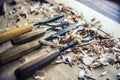 Woodworking vintage tools chisels with wood shawings on retro workbench