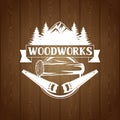 Woodworks label with wood log and saw. Emblem for forestry and lumber industry Royalty Free Stock Photo