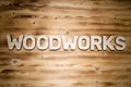 WOODWORKS word made of wooden block letters on wooden board