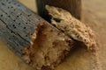 Woodworm holes in a crumbled piece of wood Royalty Free Stock Photo